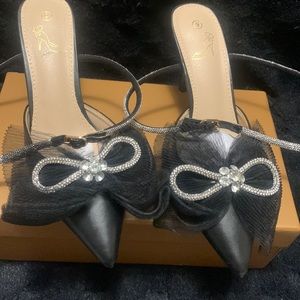 Women Black heels with diamonds bows.